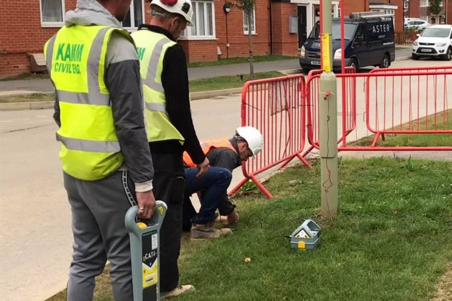 Operatives using a cable avoidance tool and signal generator