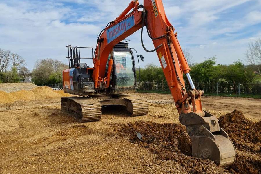 Excavator levelling ground on a Hampshire construction site